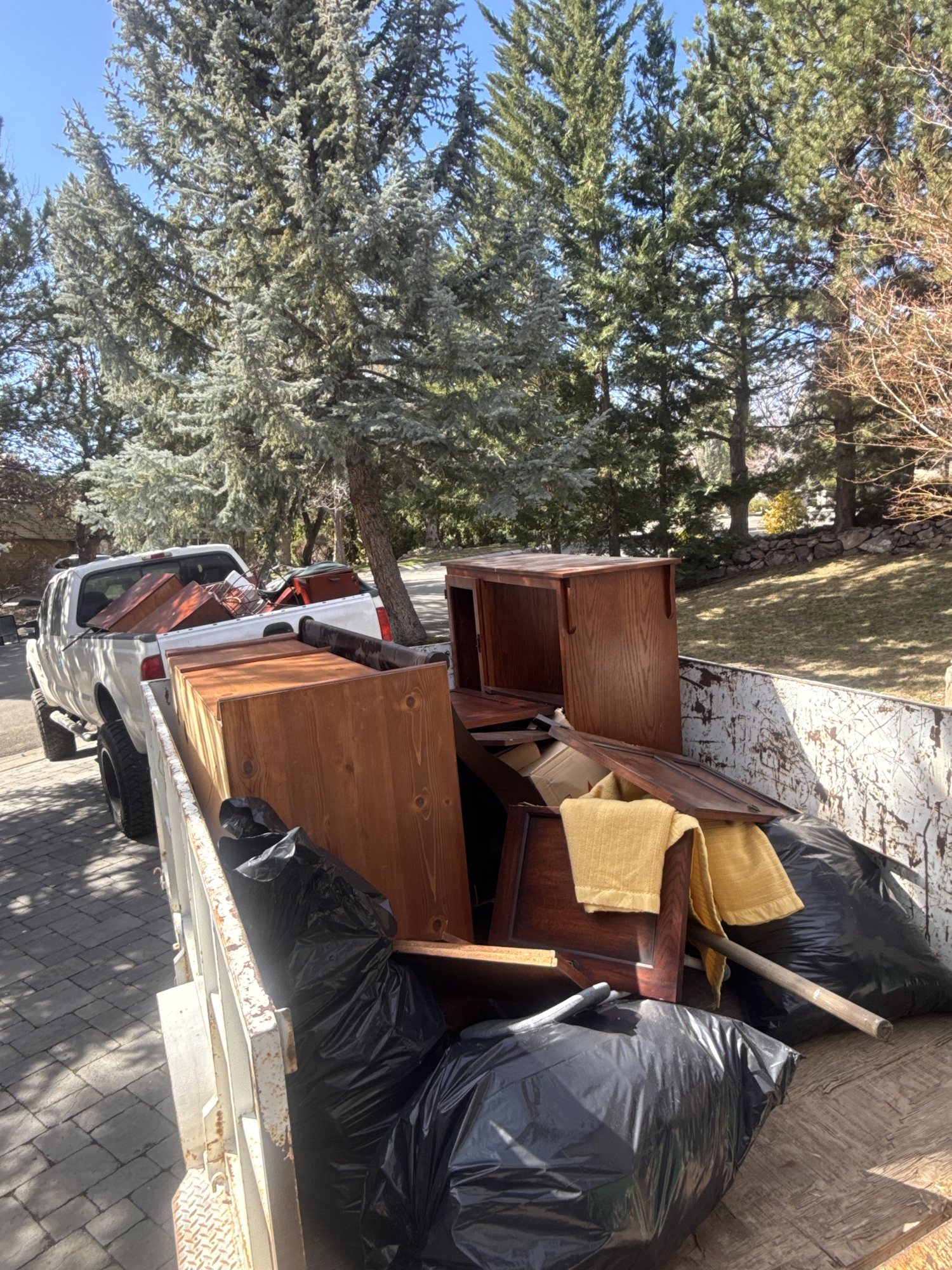 Truck and trailer loaded with furniture and junk for hauling